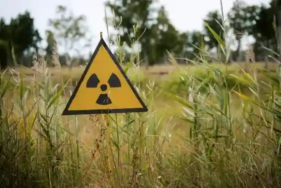 Radioactive sign outside in grass field